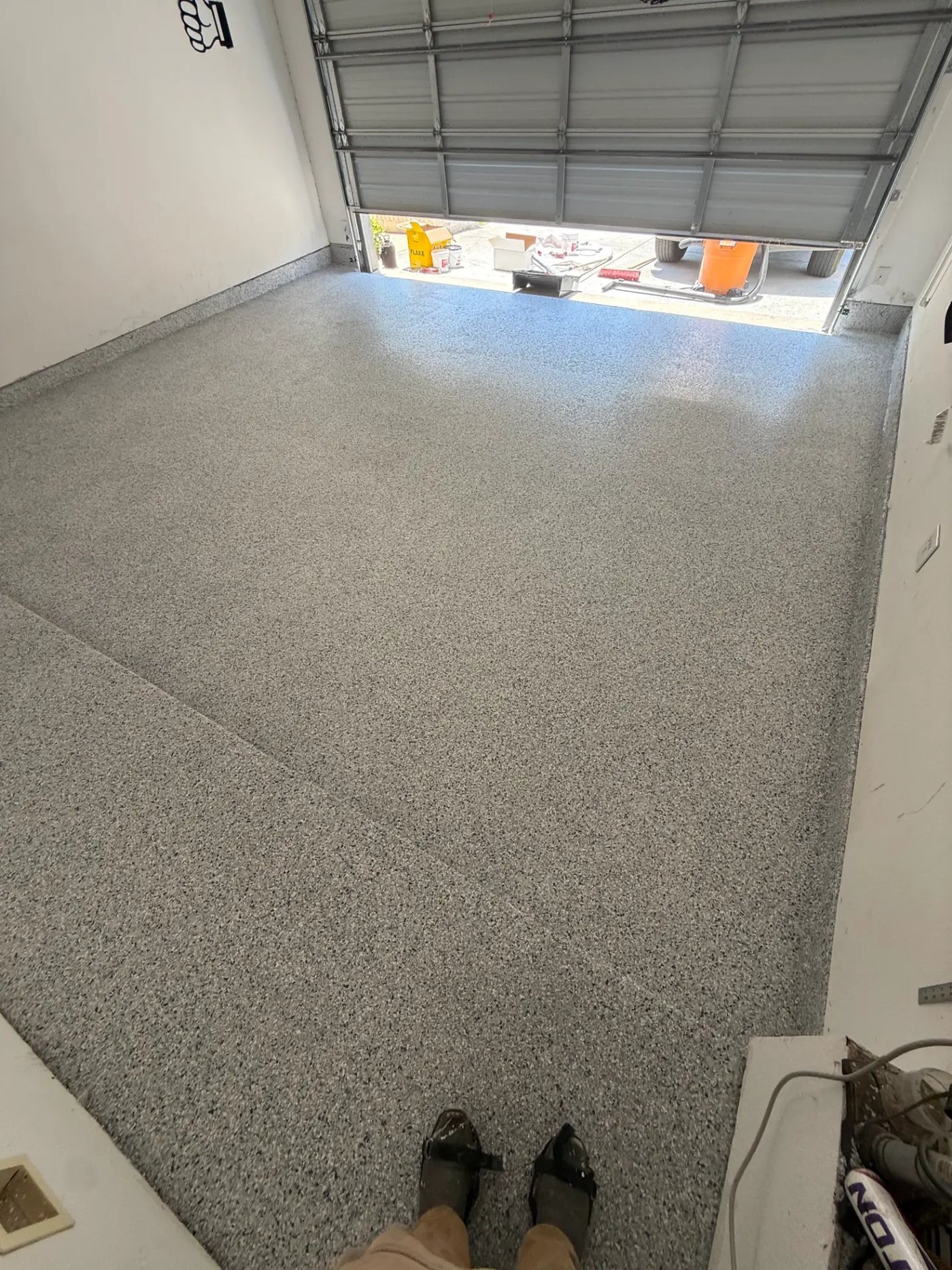 Gray and black full-flake epoxy garage floor with high-gloss topcoat installed by IronCoat Epoxy Co. in DFW