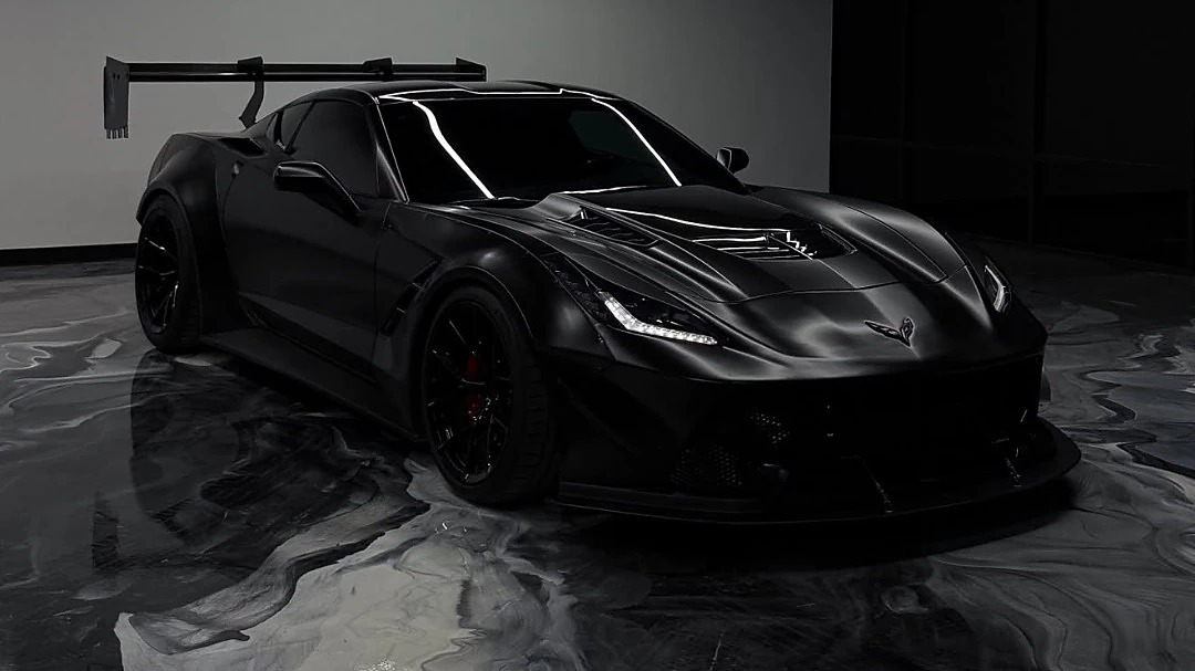 Blacked-out Corvette on a high-gloss black and silver metallic epoxy showroom floor installed by IronCoat Epoxy Co. in DFW